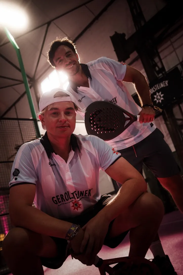 Two padel players in Gerolsteiner kits, close portrait on court